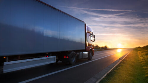 Truck transportation on the road at sunset